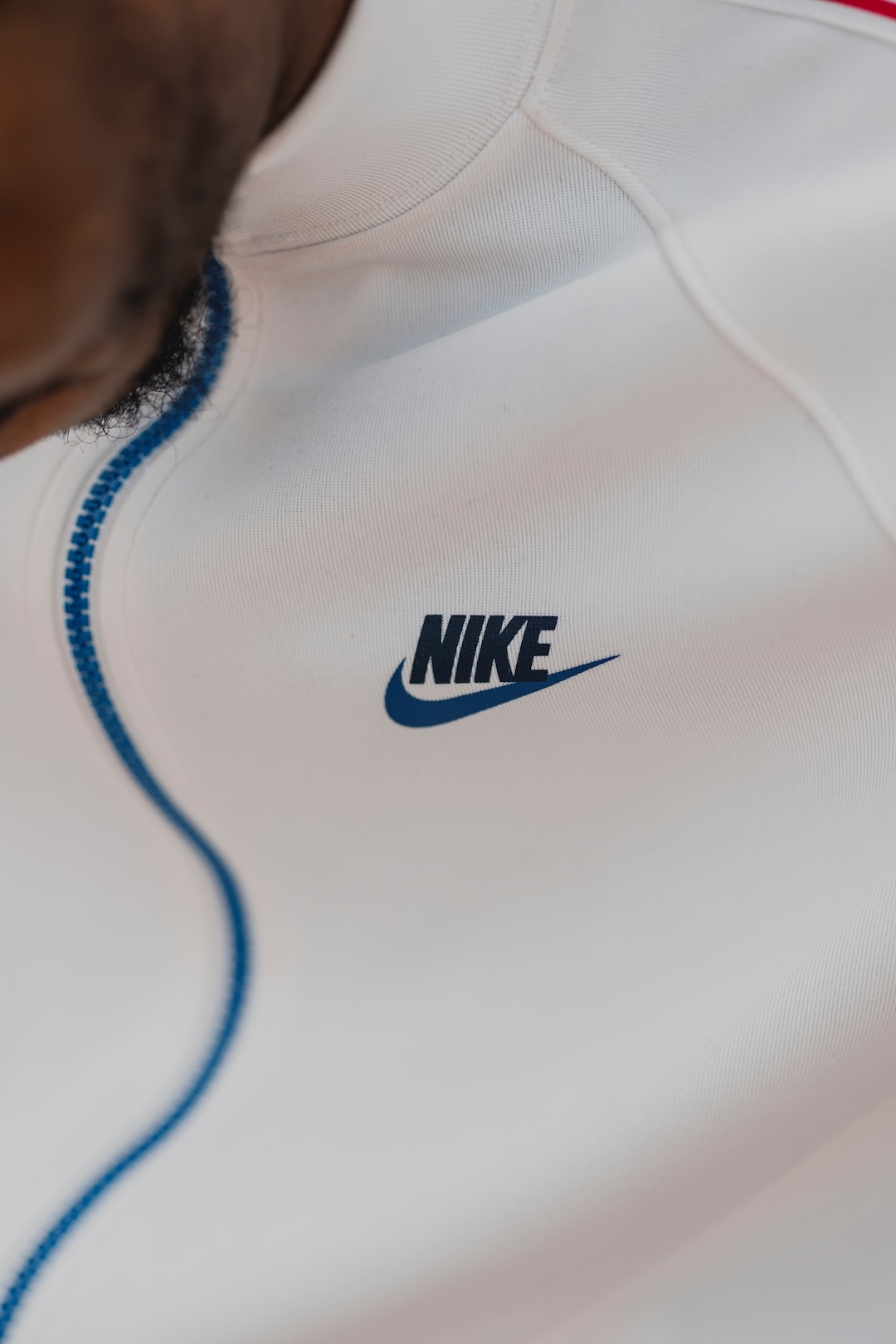 Background: Nike's Rise to the Top by Athletic Brands person in white nike crew neck shirt