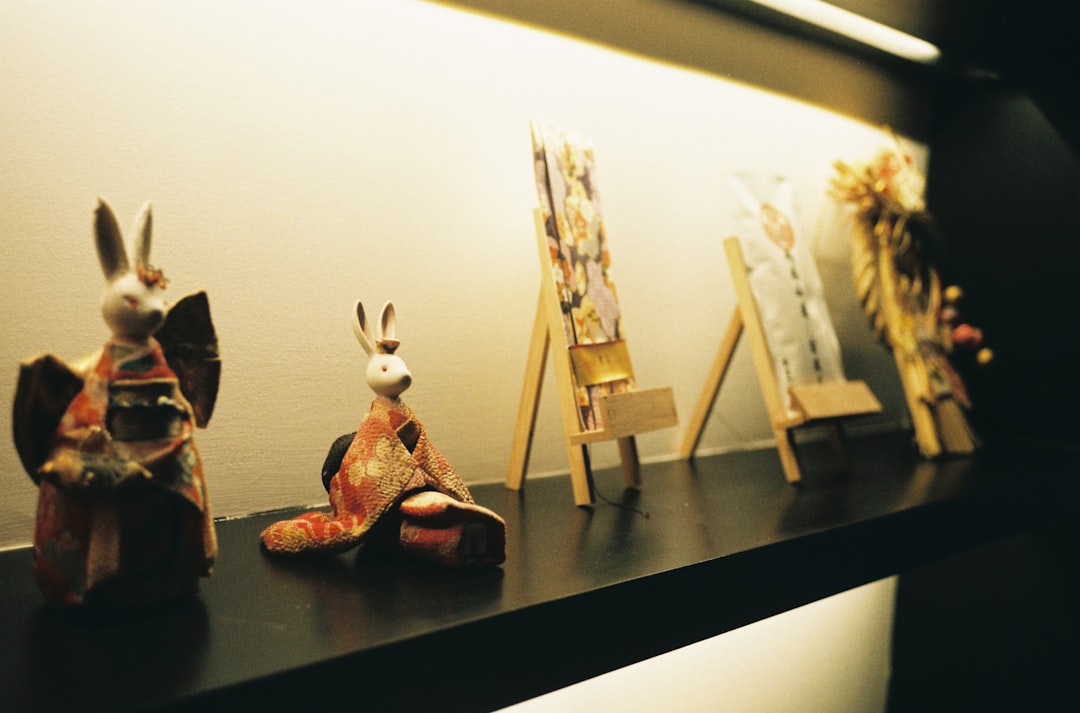 white and red animal figurine on black wooden table